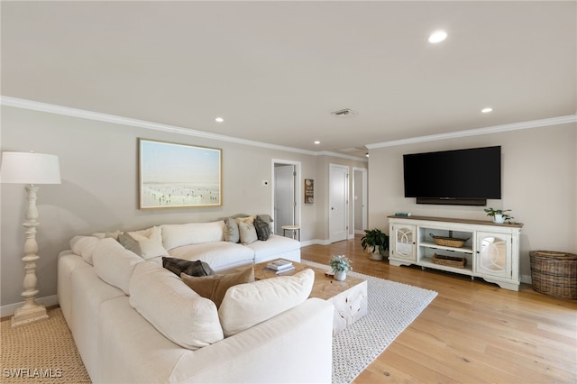 living room featuring light hardwood / wood-style floors and ornamental molding