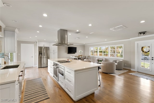 kitchen featuring white cabinetry, sink, ventilation hood, appliances with stainless steel finishes, and light wood-type flooring