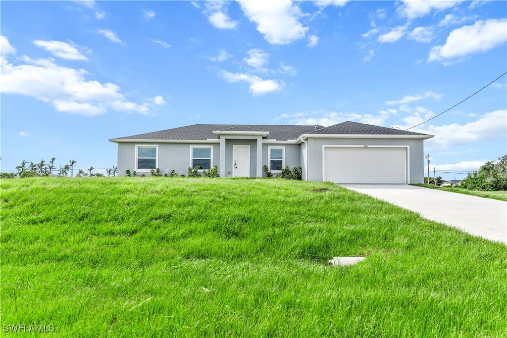 view of front of house featuring a garage and a front lawn