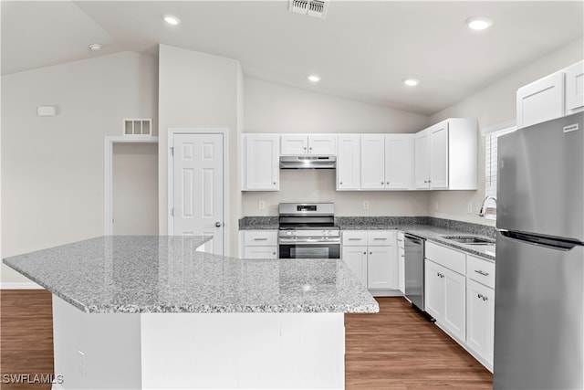 kitchen with stainless steel appliances, lofted ceiling, sink, and white cabinets