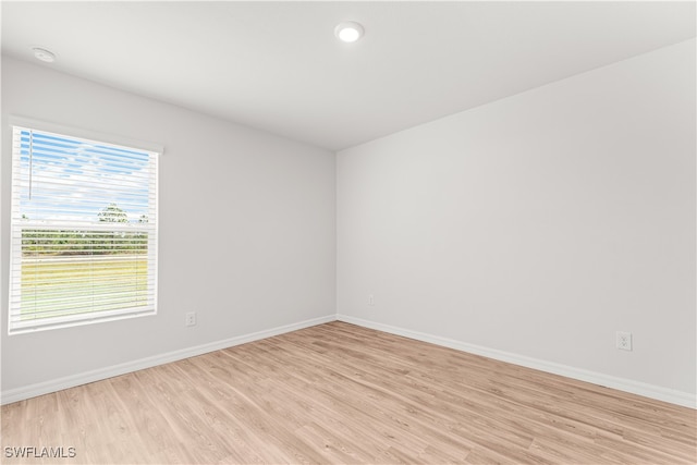 unfurnished room featuring light wood-type flooring and a wealth of natural light