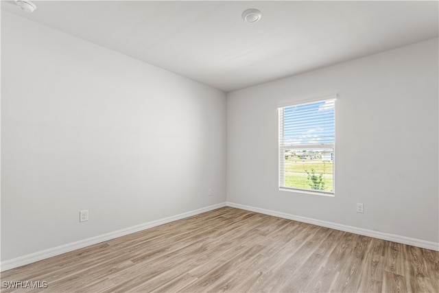 unfurnished room with light wood-type flooring