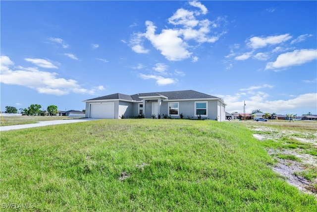 ranch-style house featuring a garage and a front lawn