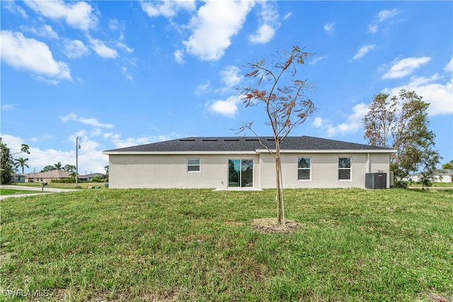 back of house with a lawn and cooling unit