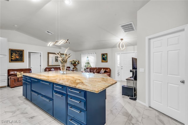 kitchen featuring lofted ceiling, a kitchen island, blue cabinets, and decorative light fixtures