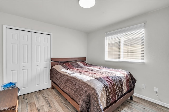 bedroom featuring light wood-type flooring and a closet