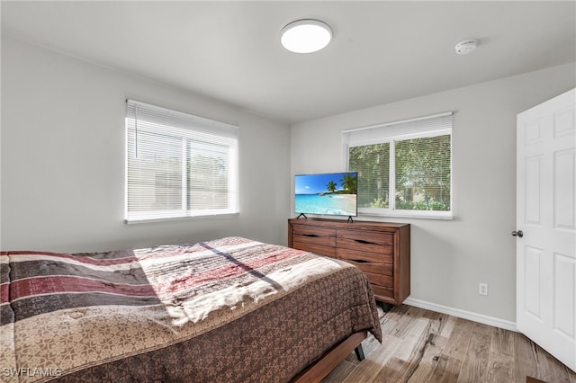 bedroom featuring light wood-type flooring and multiple windows