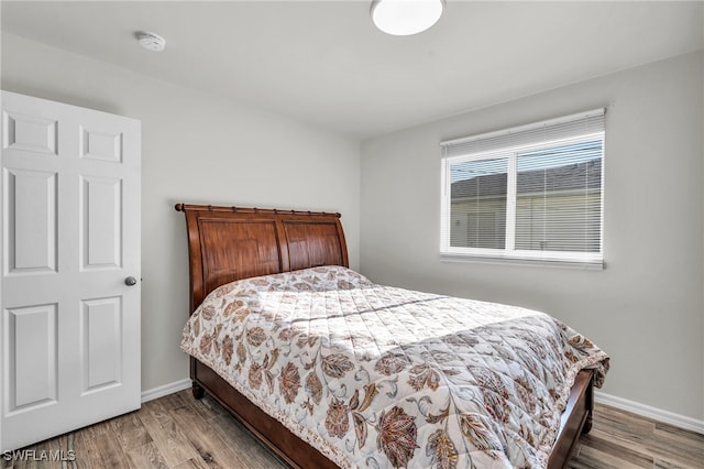 bedroom with hardwood / wood-style floors