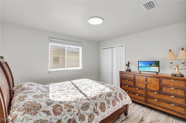 bedroom with light wood-type flooring and a closet