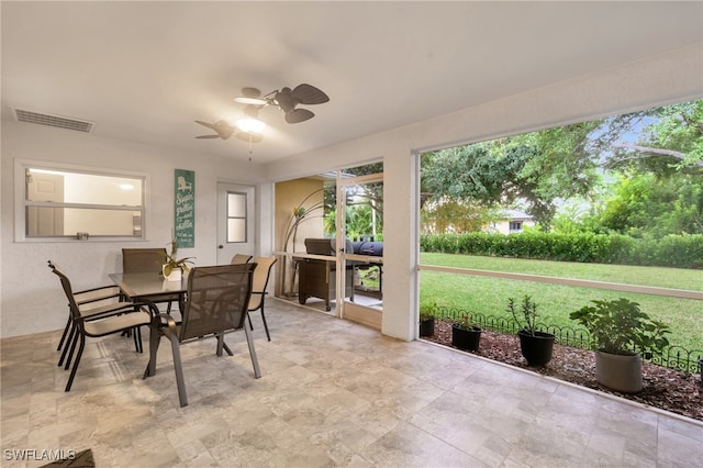 interior space with ceiling fan