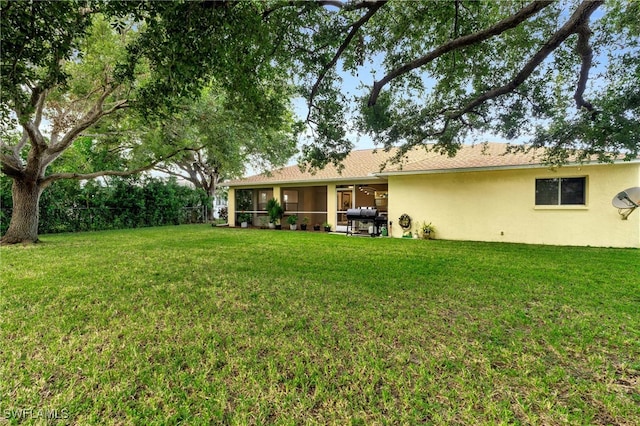 view of yard with a patio and a sunroom