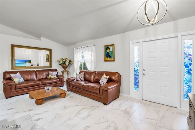 living room with an inviting chandelier and lofted ceiling