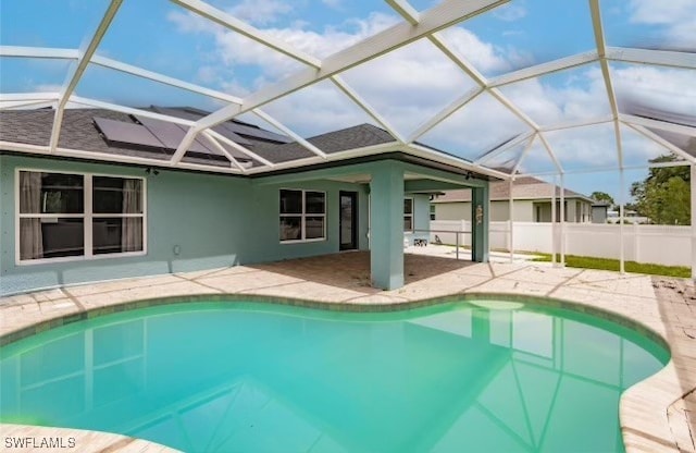 view of swimming pool featuring a lanai and a patio area