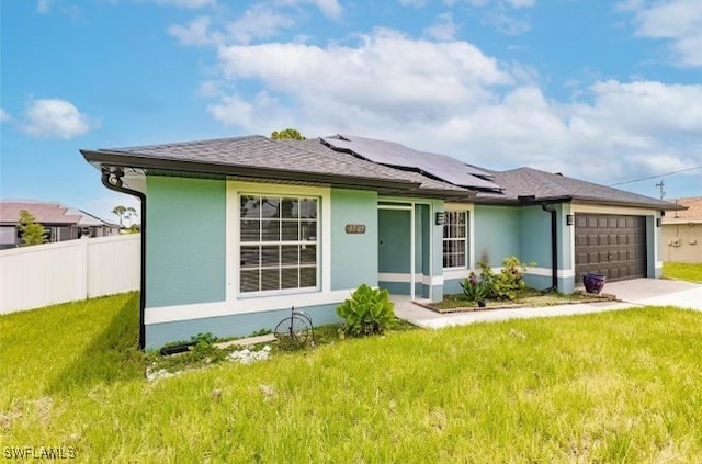 exterior space with a front yard, a garage, and solar panels