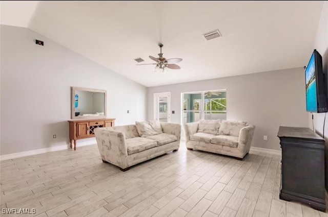 living room with ceiling fan, vaulted ceiling, and light hardwood / wood-style floors