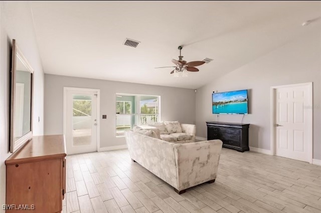 living room with light hardwood / wood-style floors, lofted ceiling, and ceiling fan