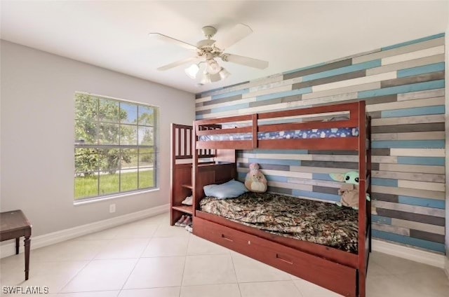 tiled bedroom featuring ceiling fan