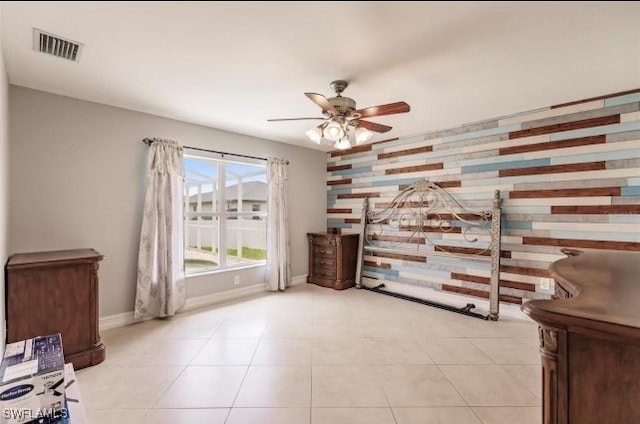 living area with ceiling fan and light tile patterned flooring