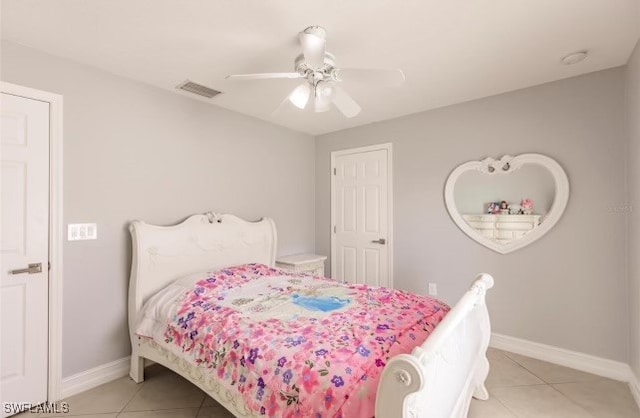 tiled bedroom featuring ceiling fan