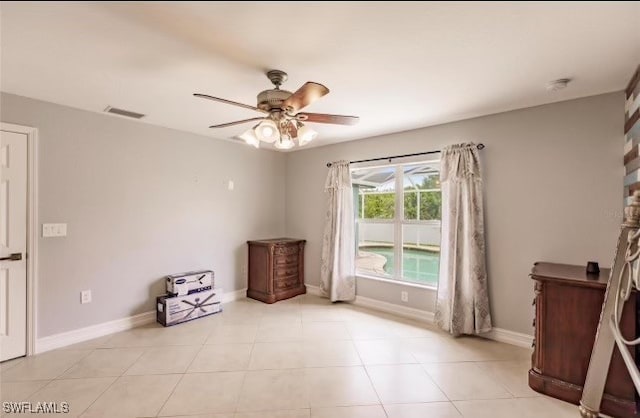 interior space with light tile patterned floors and ceiling fan