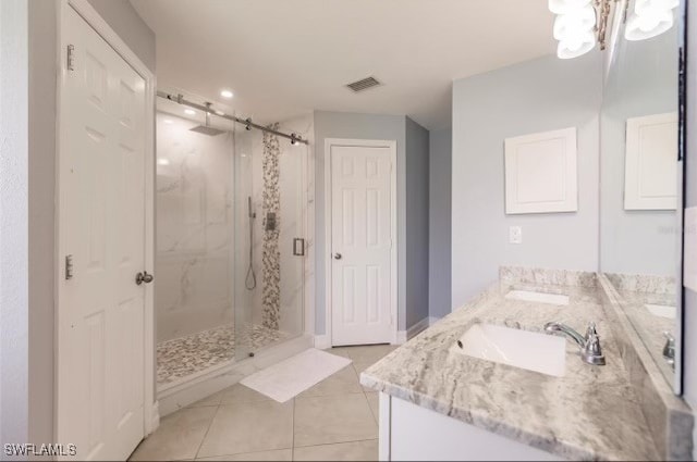 bathroom featuring tile patterned floors, walk in shower, and vanity