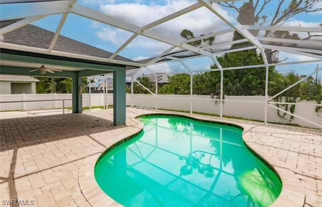 view of pool featuring a lanai, a patio area, and ceiling fan