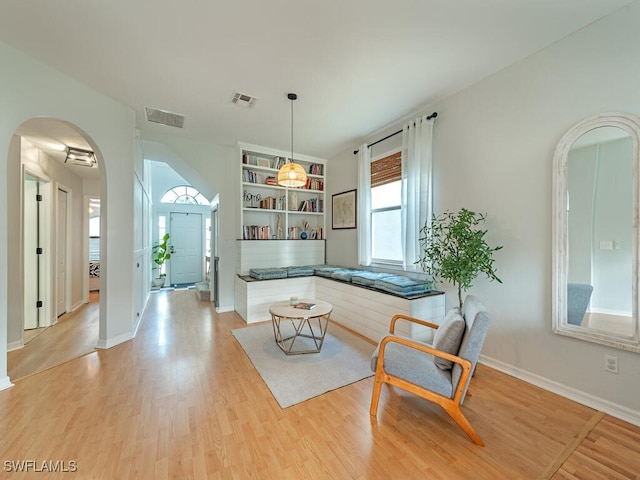 interior space featuring built in features and light hardwood / wood-style flooring