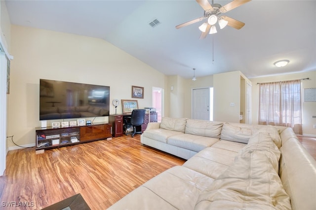 living room with ceiling fan, lofted ceiling, and light hardwood / wood-style flooring