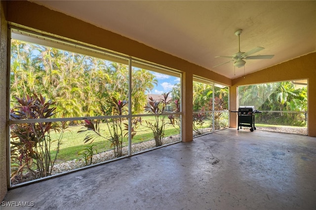 unfurnished sunroom with lofted ceiling and ceiling fan