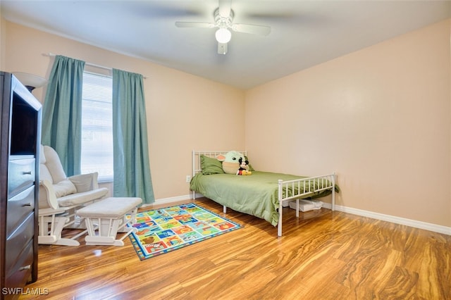 bedroom featuring hardwood / wood-style flooring and ceiling fan