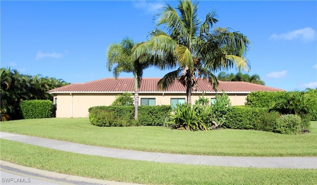 11599 Meadowrun Cir, Fort Myers, FL 33913 - view of front of house featuring a tile roof, a front yard, and stucco siding