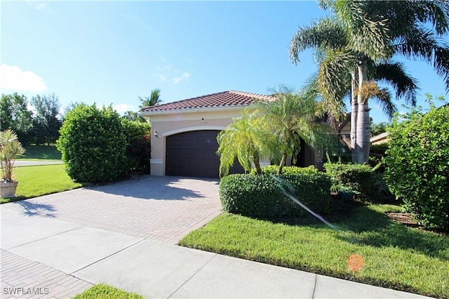 11599 Meadowrun Cir, Fort Myers, FL 33913 - mediterranean / spanish house featuring decorative driveway, an attached garage, a front yard, stucco siding, and a tile roof