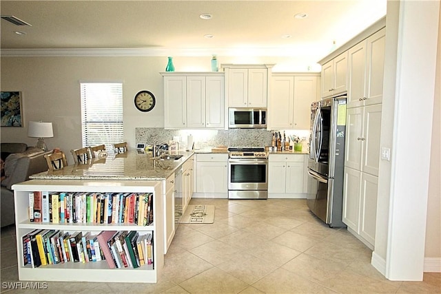 11599 Meadowrun Cir, Fort Myers, FL 33913 - kitchen featuring stainless steel appliances, a sink, ornamental molding, a peninsula, and tasteful backsplash