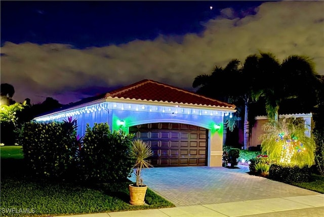 11599 Meadowrun Cir, Fort Myers, FL 33913 - view of front of house with an attached garage, stucco siding, driveway, and a tiled roof