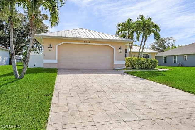 view of front of house with a garage and a front yard