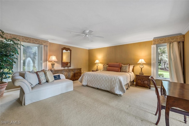 carpeted bedroom with ceiling fan and crown molding