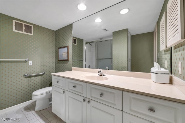 bathroom featuring walk in shower, vanity, toilet, and tile patterned floors