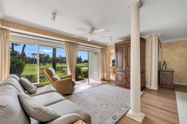 living room featuring ceiling fan, ornamental molding, light hardwood / wood-style flooring, and ornate columns