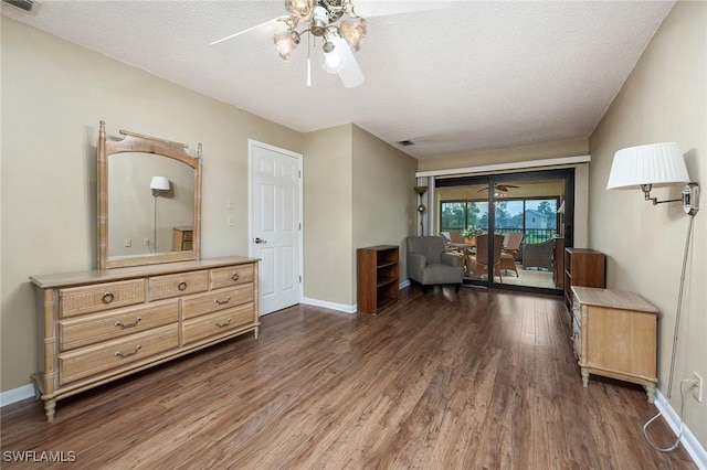 interior space with dark wood-type flooring and a textured ceiling