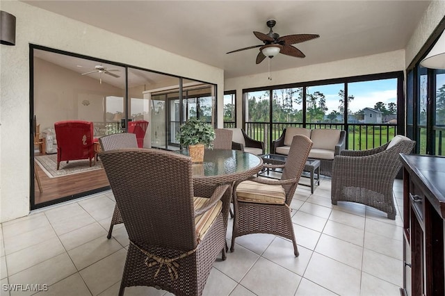 sunroom / solarium featuring a ceiling fan and lofted ceiling