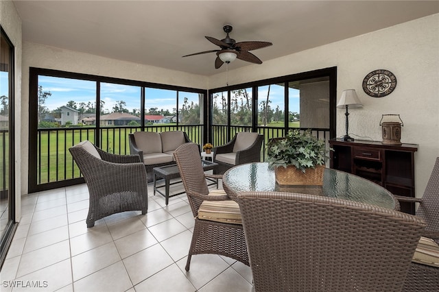 sunroom featuring ceiling fan and a healthy amount of sunlight