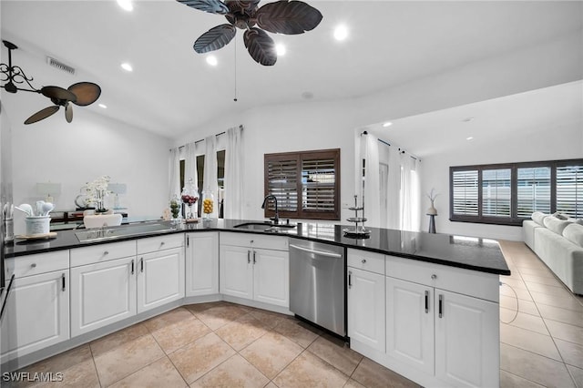 kitchen featuring appliances with stainless steel finishes, dark countertops, open floor plan, and a sink