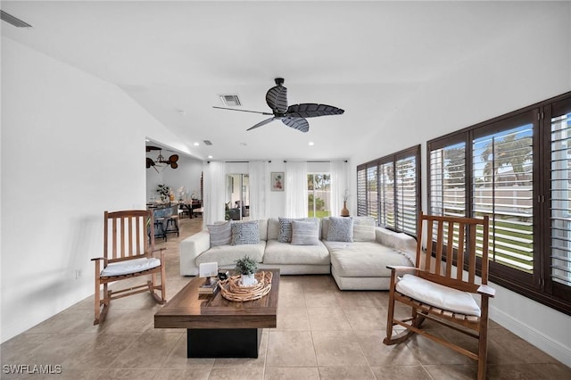 living area with ceiling fan, light tile patterned flooring, visible vents, and baseboards