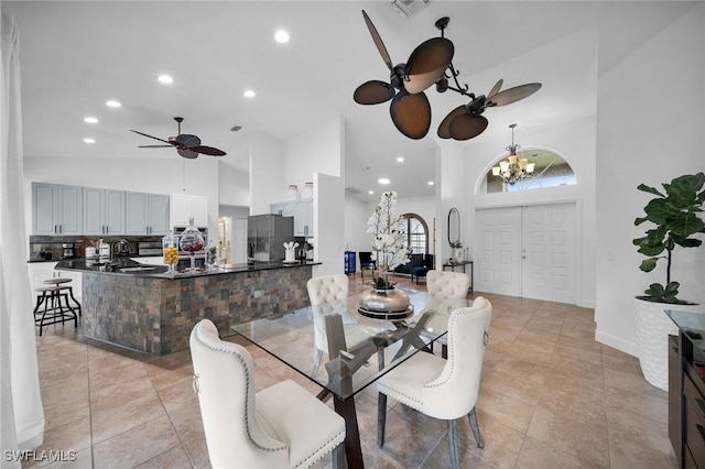 dining area with recessed lighting, visible vents, high vaulted ceiling, and ceiling fan with notable chandelier