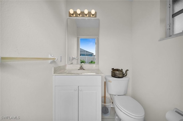 half bathroom with vanity and toilet