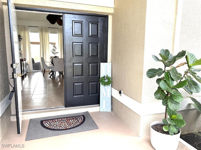 entrance to property featuring stucco siding