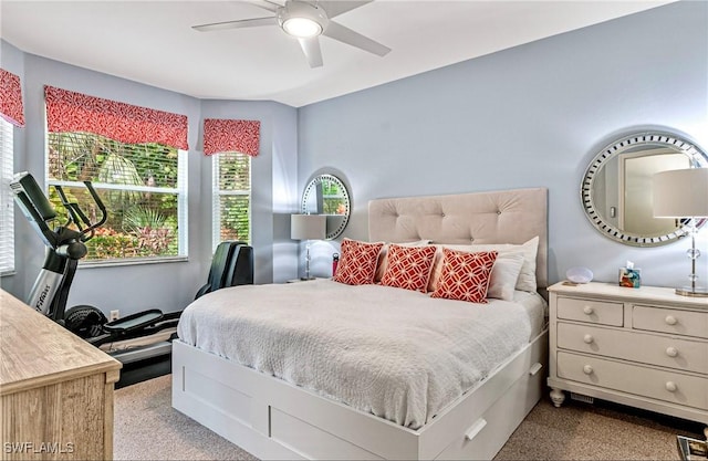 bedroom with ceiling fan and light carpet