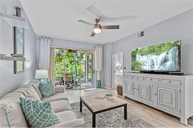 living room with light hardwood / wood-style floors and ceiling fan