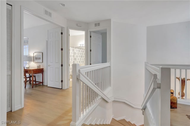 stairway featuring wood-type flooring