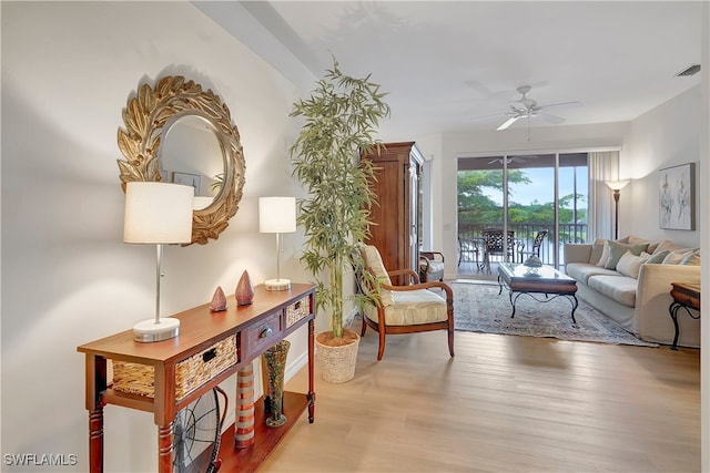 living room with light wood-type flooring and ceiling fan